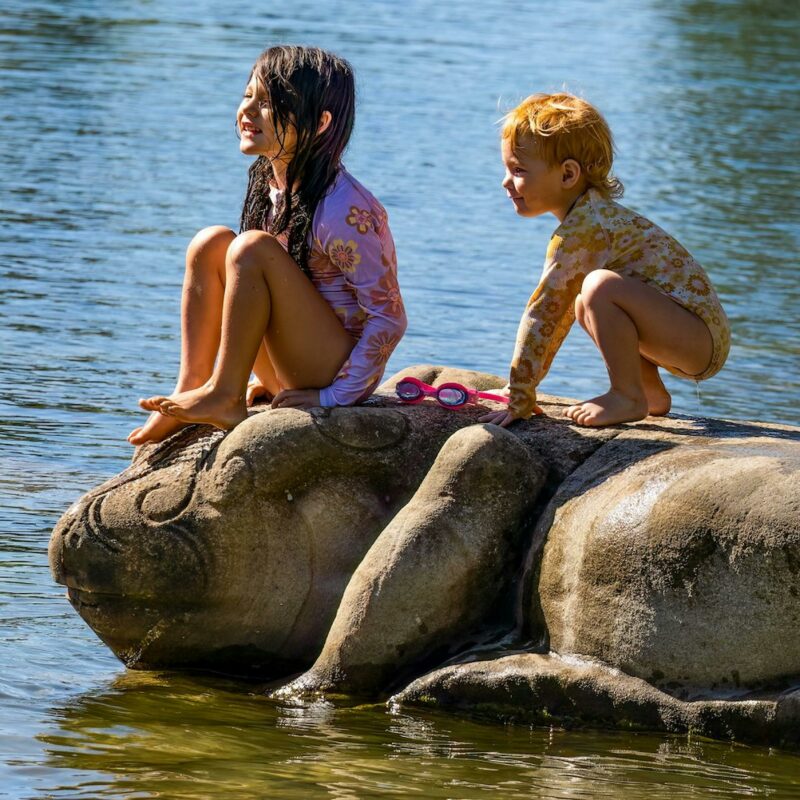 two children playing in the lake