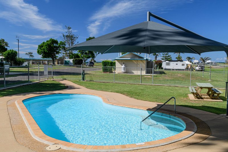Swimming pool with shade umbrella.