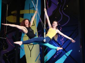 Adults and Teens Aerial Classes and Workshops - Pictured is a lady and teen girl sitting on Trapeze.