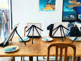 Wooden table set up with desk top easels, canvases and paints