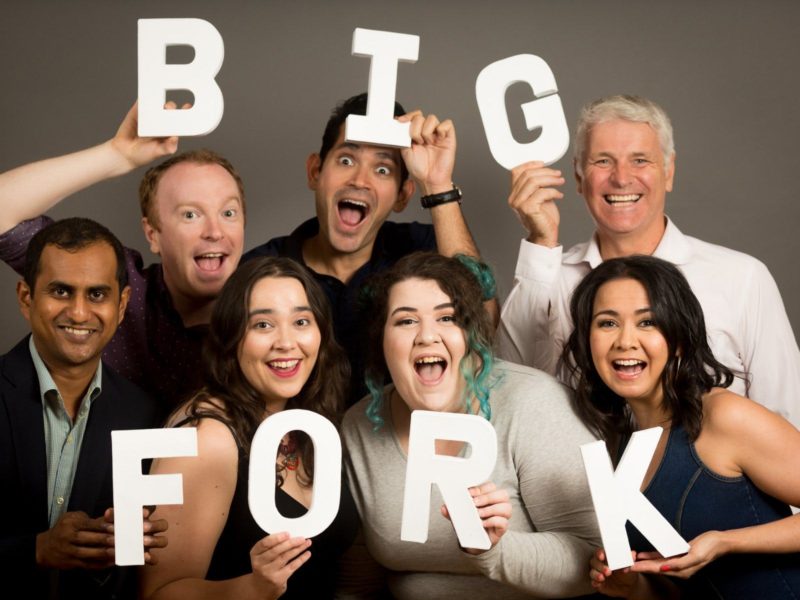 Some of the performers of Big Fork Theatre holding the letters B I G F O R K and smiling