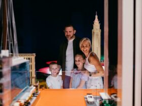 Family of 4 looking in awe at LEGO exhibition