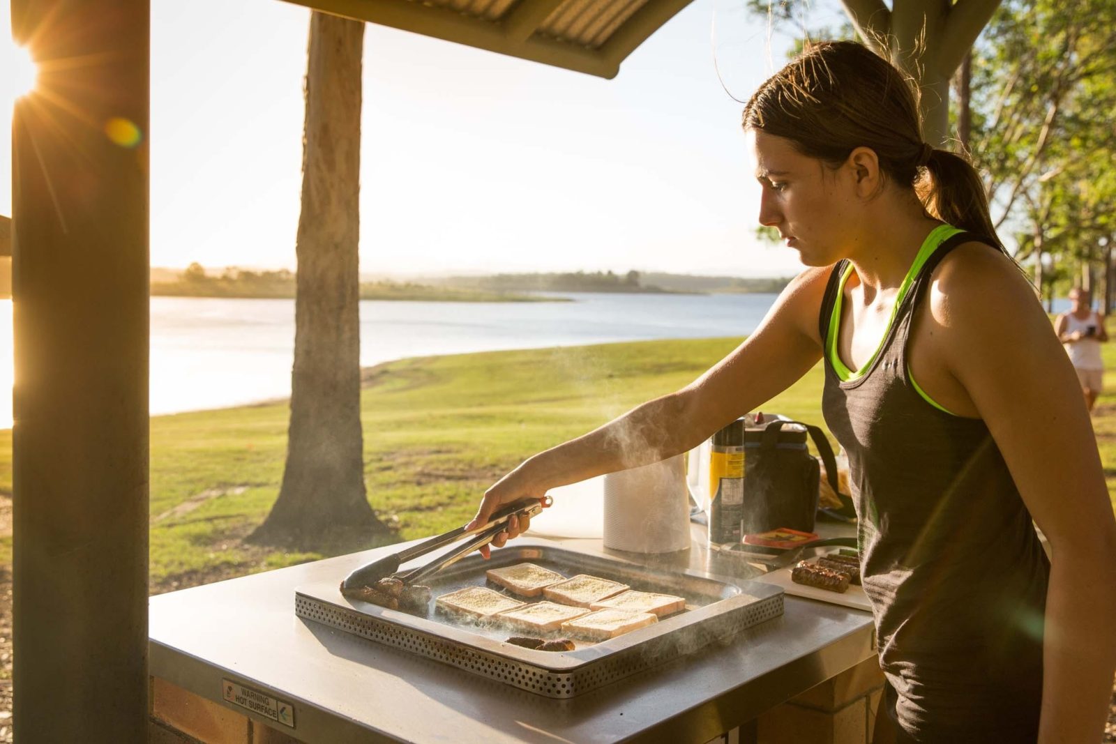 A woman cooking with views of Lake Samsonvale, Bullocky Rest