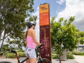 A girl looking at the map of the Caboolture to Wamuran Rail Trail