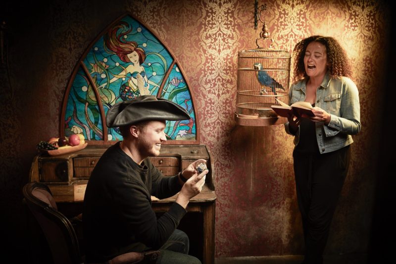 2 players reading clues in a pirate themed escape room