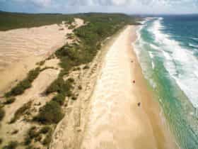 Long white sandy beach and vehicles, Fraser Island
