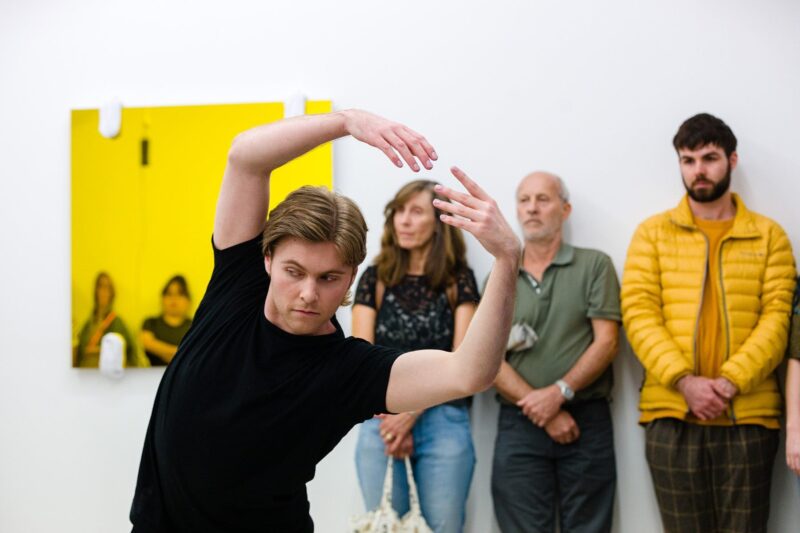Person with arms outstretched above their head dancing