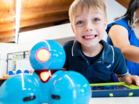 Young boy playing with our Dojo robots.