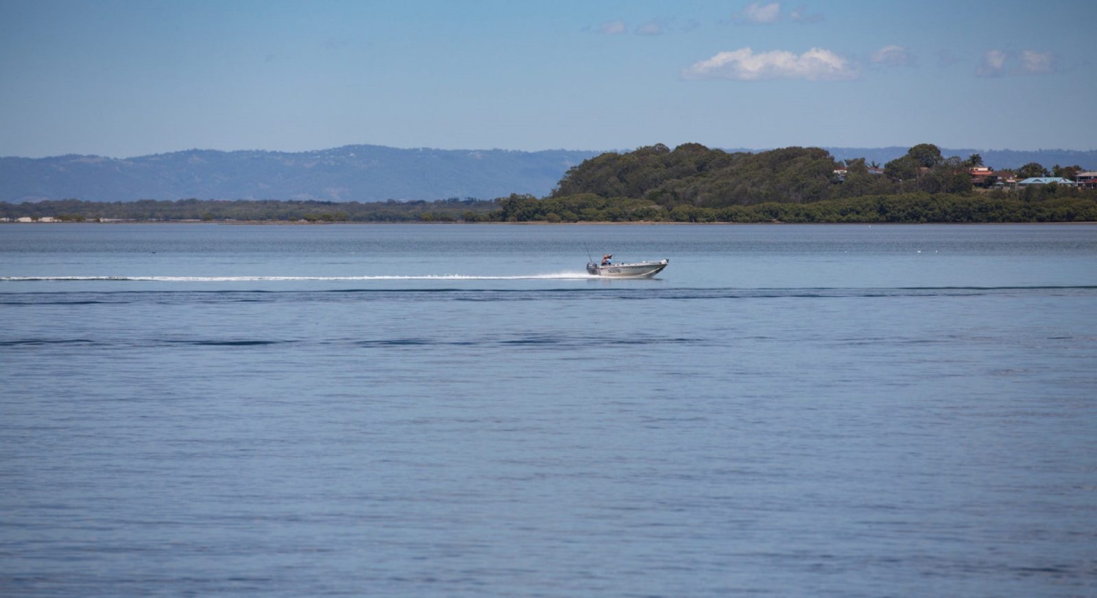Tinny gliding gliding over the water in Pumicestone Passage