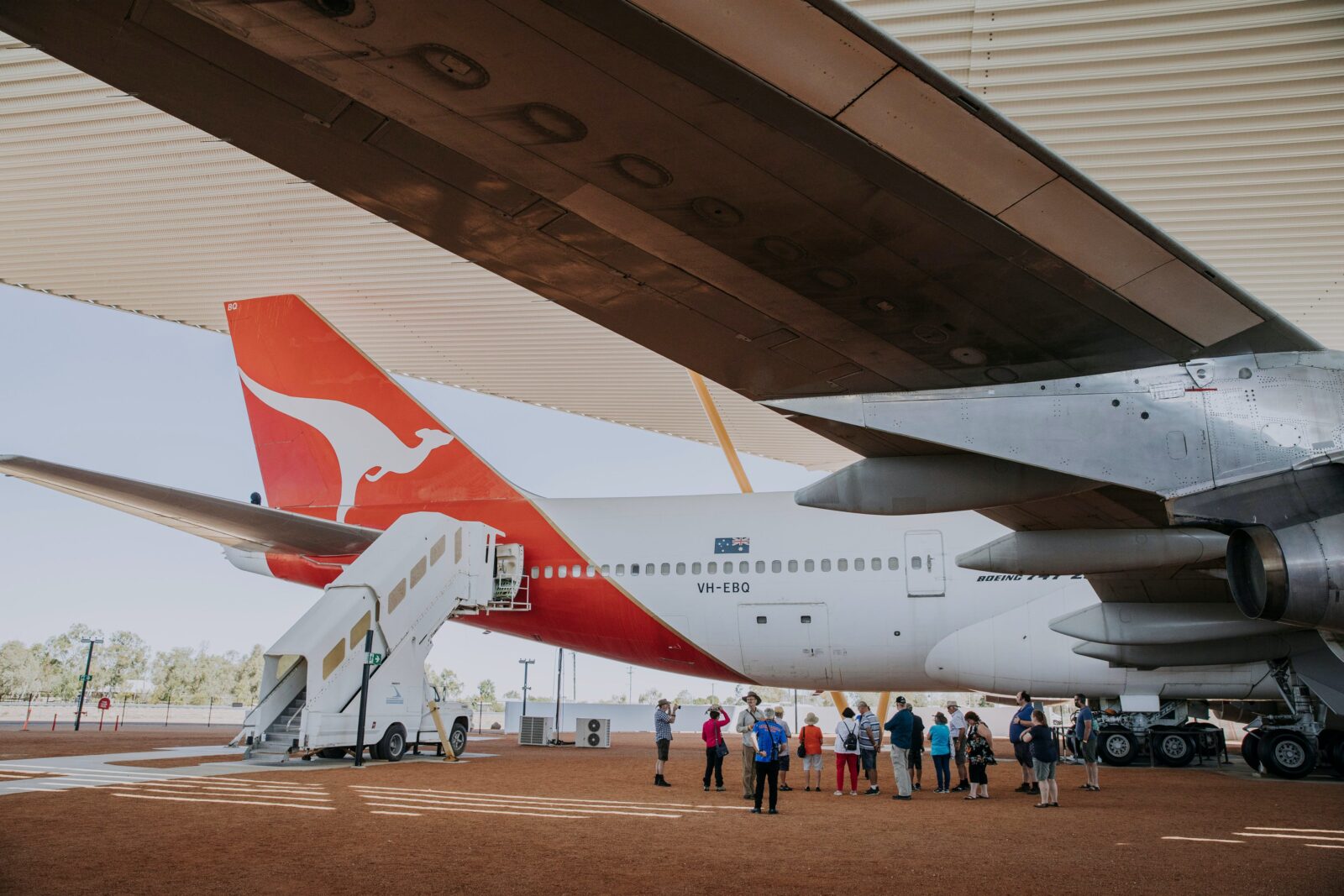 Image captured by Tourism & Events Queensland of an airpark tour taking place under the 747 wing.