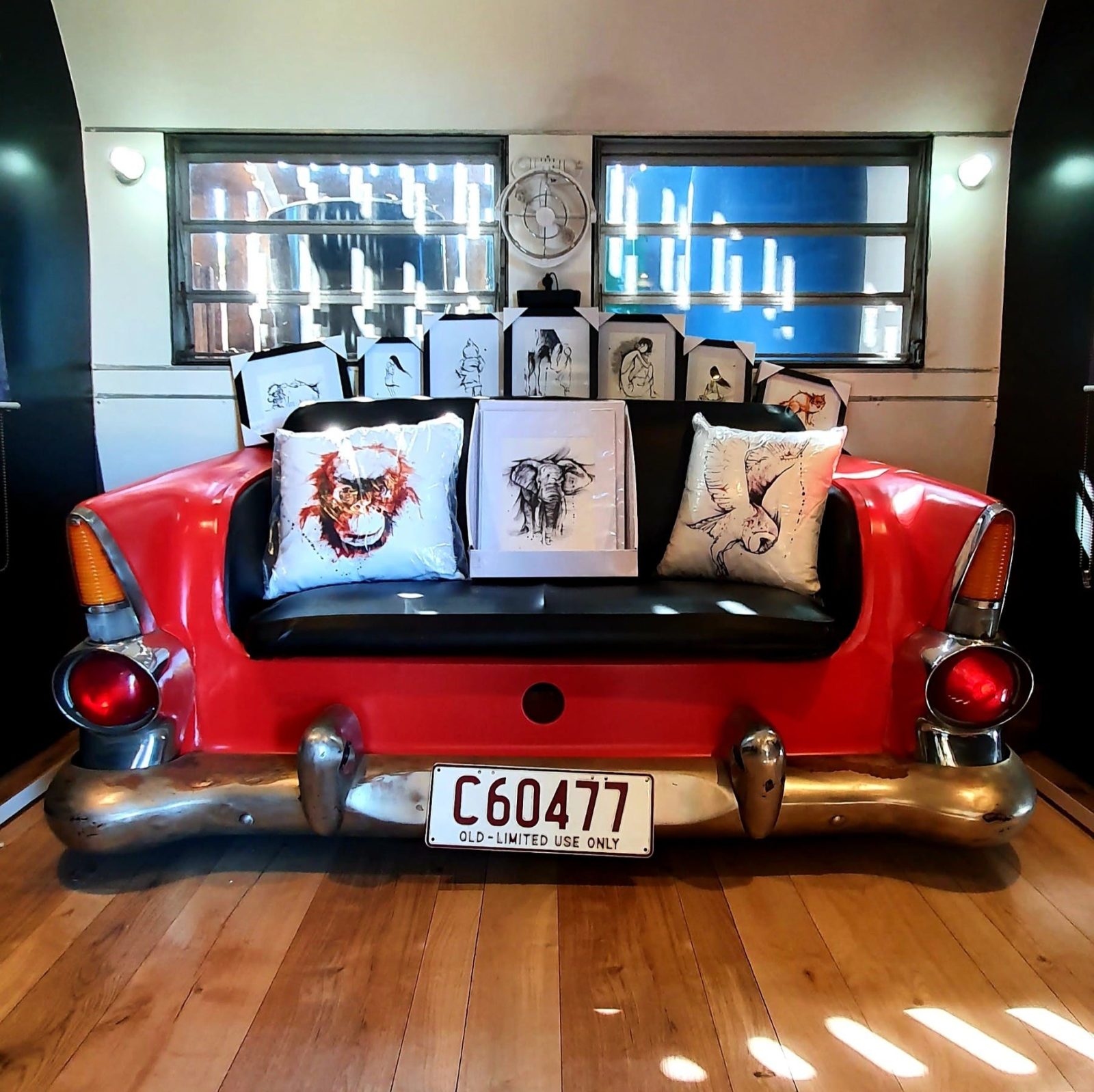 photo of red car seat with artworks sitting on it