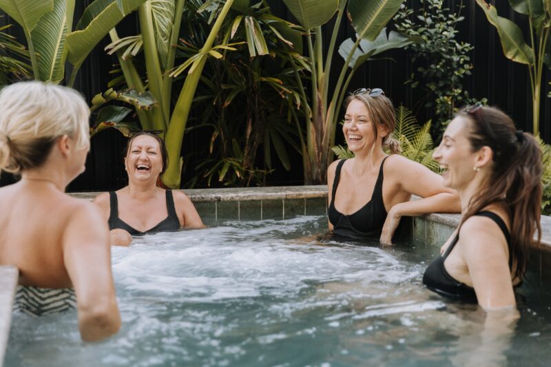 Relax with friends in the outdoor hot mineral pools at Soak Bathhouse Mermaid Beach