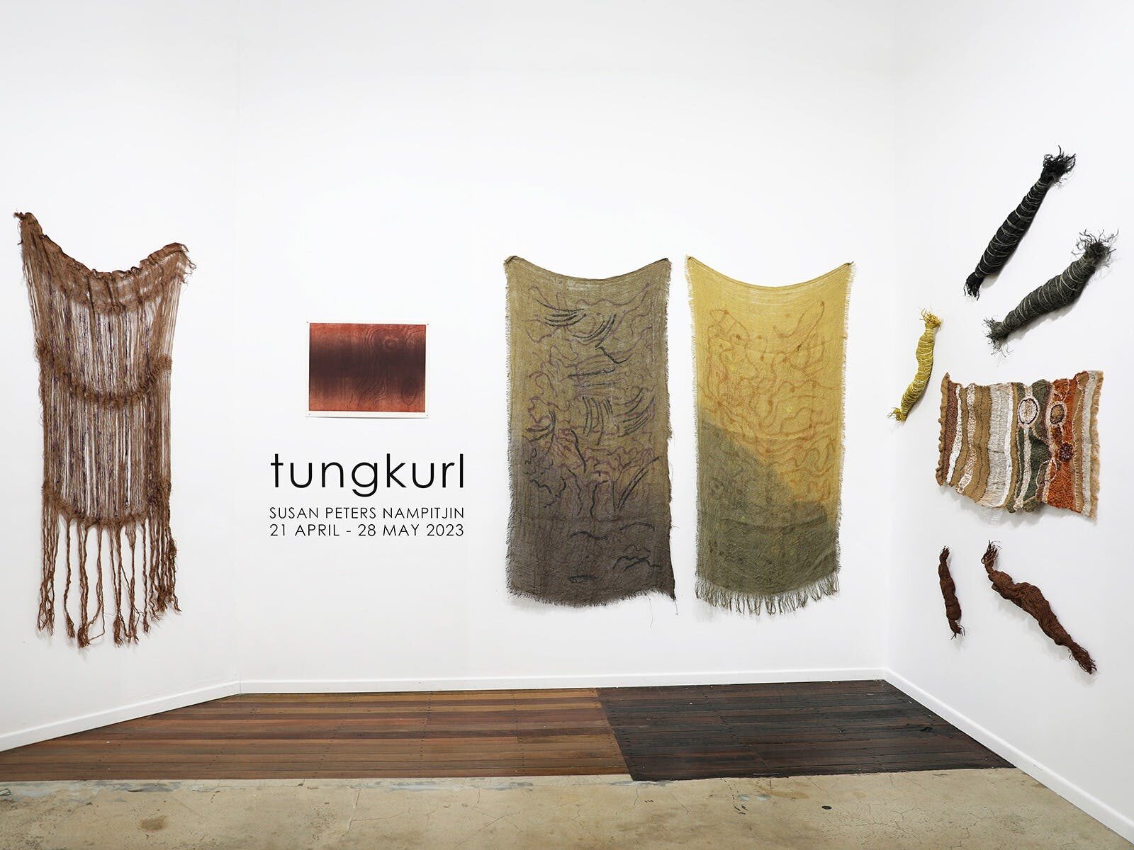 Detail from Susan Peters Nampitjin's exhibition 'Tungkurl,' with prints and works on hessian.