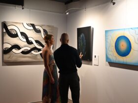 Kane Brunjes talking to a Gallery Guest about his art