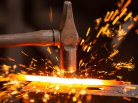 Hammer hitting steel with sparks flying.