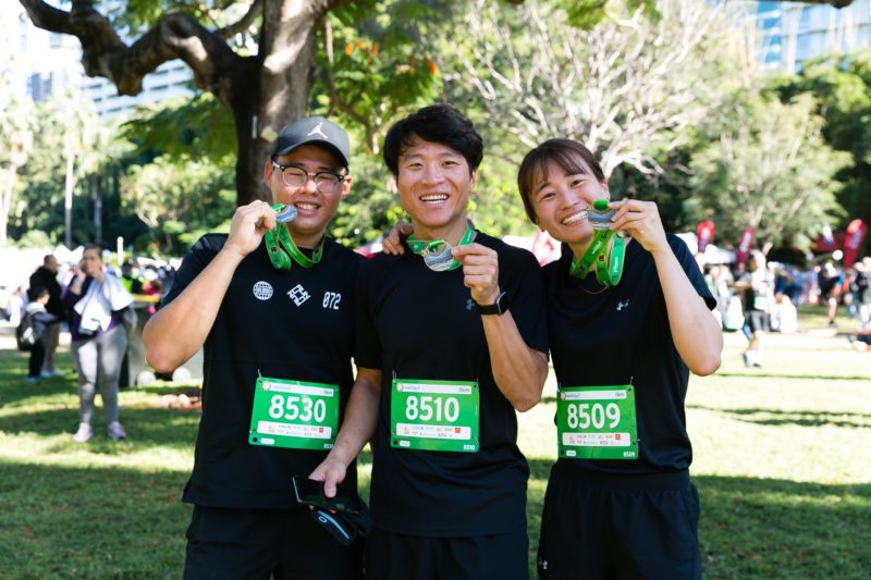 friends holding running medal