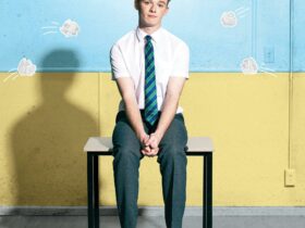 School boy on desk with paper balls