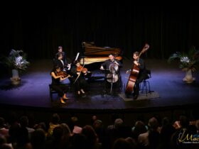 A quintet of musicians performing - violin, viola, piano, cello and double bass