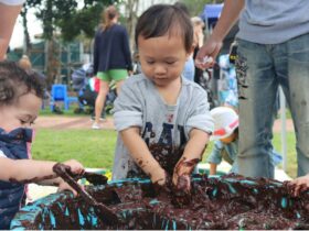 boy plays with mud messy play
