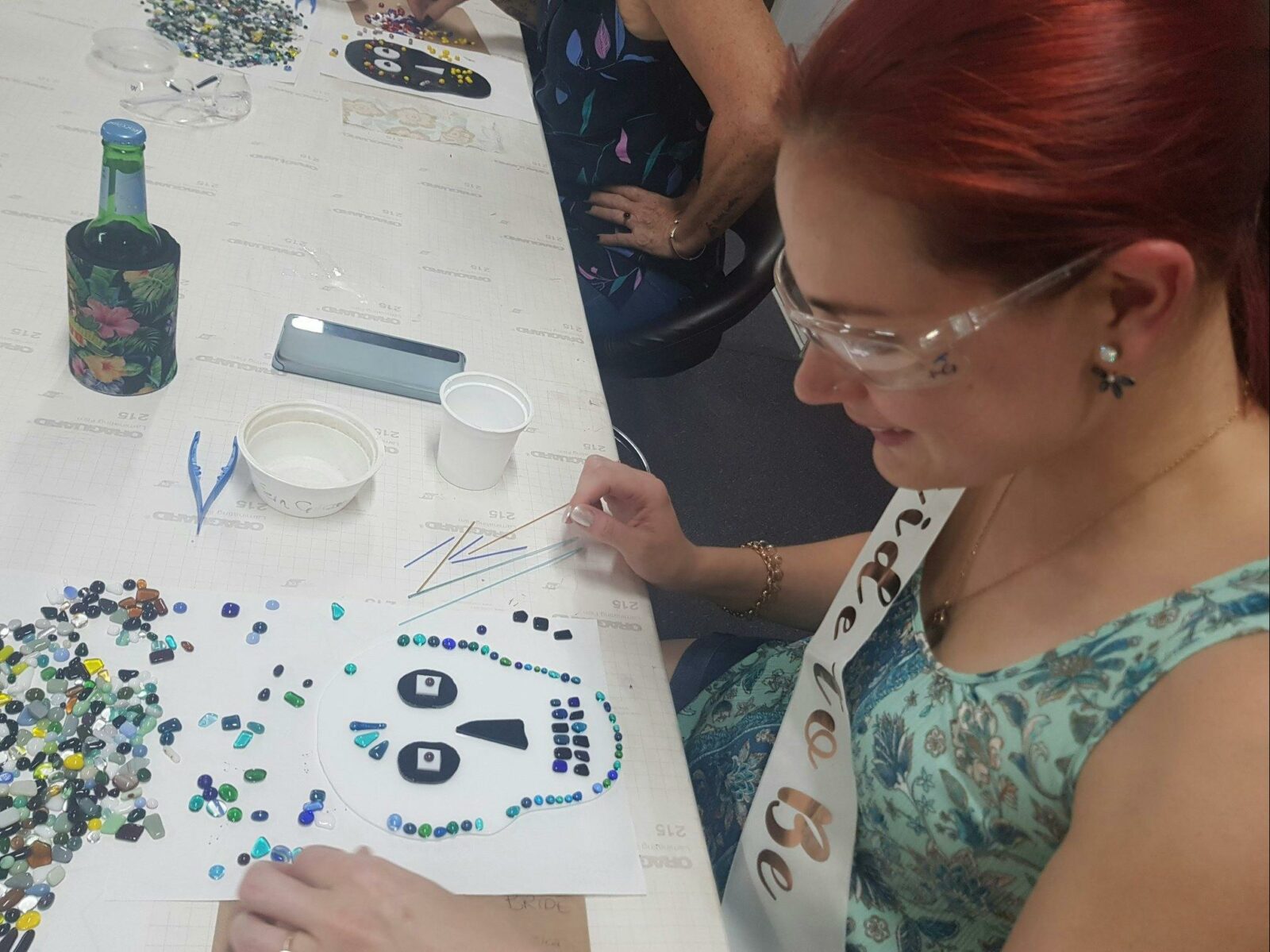 Student working with glass project, create a themed haloween sugar skull plate