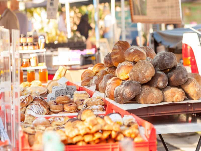 Fresh breads and pastries on display at a market stall.