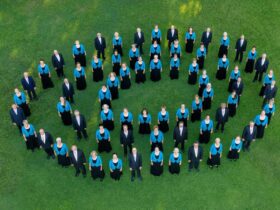 The Sunshine Coast Oriana Choir photographed above, standing in concentric circles, waving