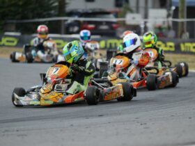 People racing in karts around a race track