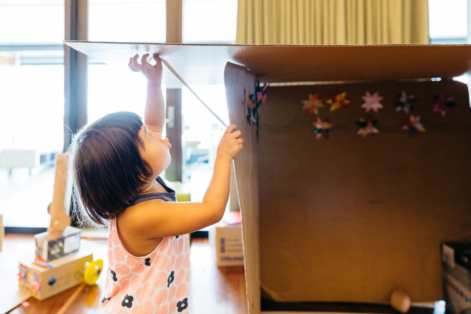Young girl creating with cardboard box