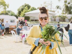 Lady holding a bouquet of fresh produce in the paddocks of Winter Harvest Festival