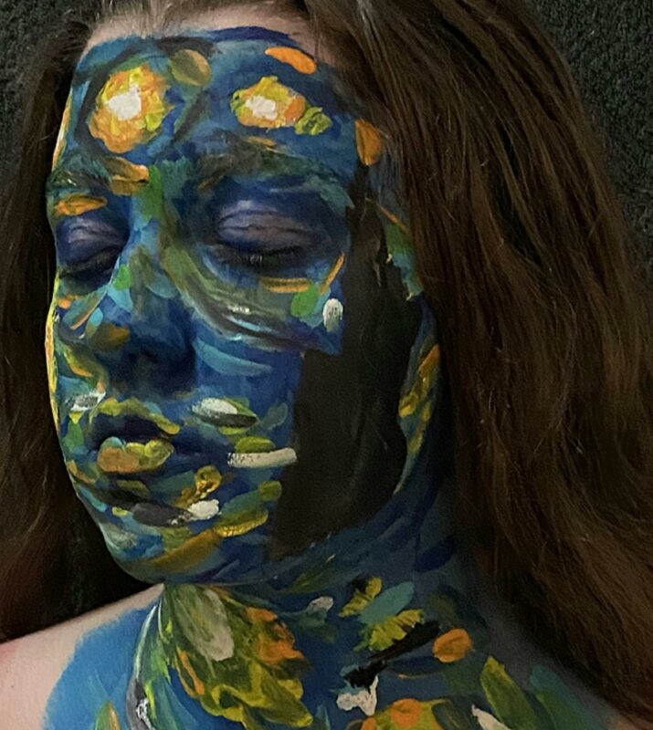 photo of girl with eyes closed and face painted