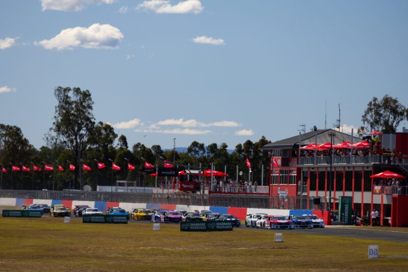 queensland raceway with red flag and cars lined up ready to race