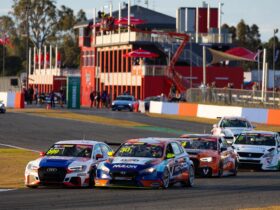 TCR Australia cars grouped together making a turn around a track