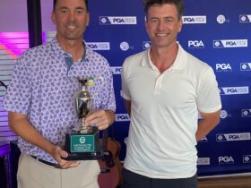 Jason Norris receives trophy from Adam Scott