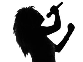 A figure of a women holding a microphone