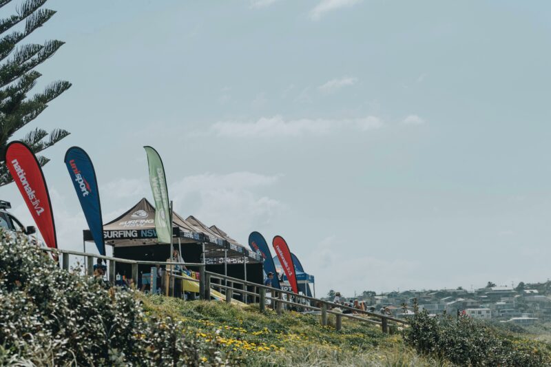 UniSport flags and tents on headland at Nationals Surfing Championships