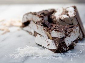 A cross section of marshmallows, dark chocolate with scattered ingredients
