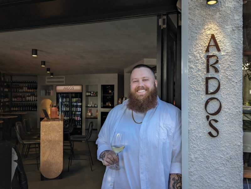 staff member with glass of wine at Ardo's Wine Bar and Cellar Door