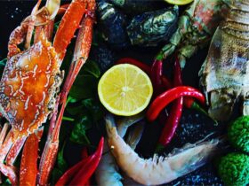 photo of a platter of fresh seafood produce such as crab, prawn, oysters, chillis, lemon