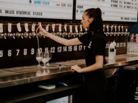 woman pouring beer from kegged tap