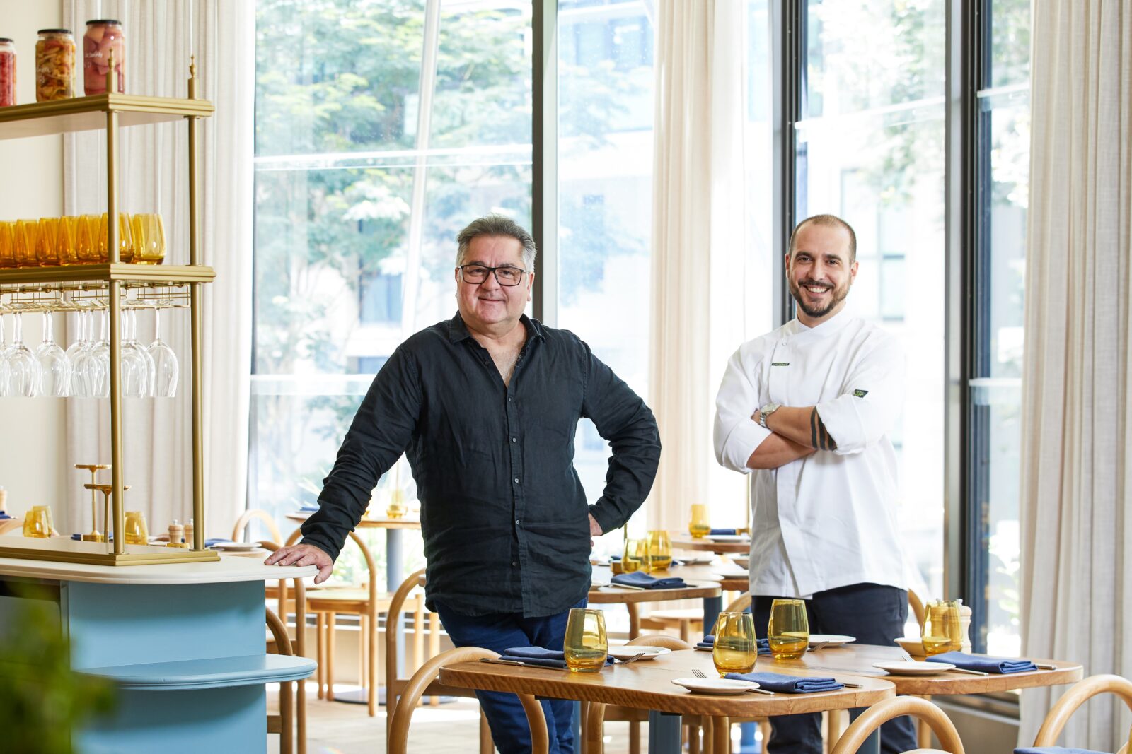 Celebrity chef & head chef both standing together in Settimo