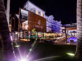 The Coral Sea Resort Hotel and The Rocks Restaurant, Bar and Pool Club at night