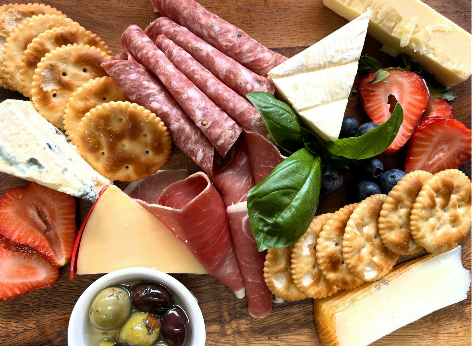 Charcuterie board of cheese, crackers and sliced meats