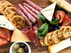 Charcuterie board of cheese, crackers and sliced meats
