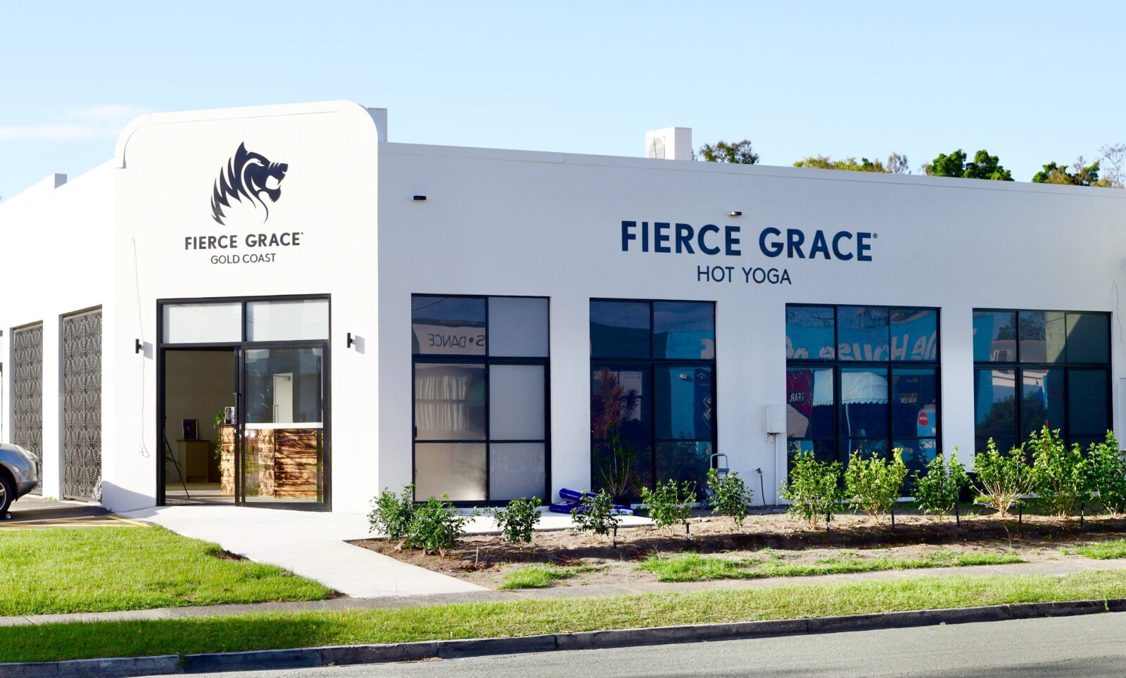 Studio Exterior Shot. Grey building with Fierce Grace branding