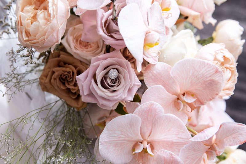 A bridal bouquet of roses and phaleanopsis orchids. In varying pink, nude and coffee tones.