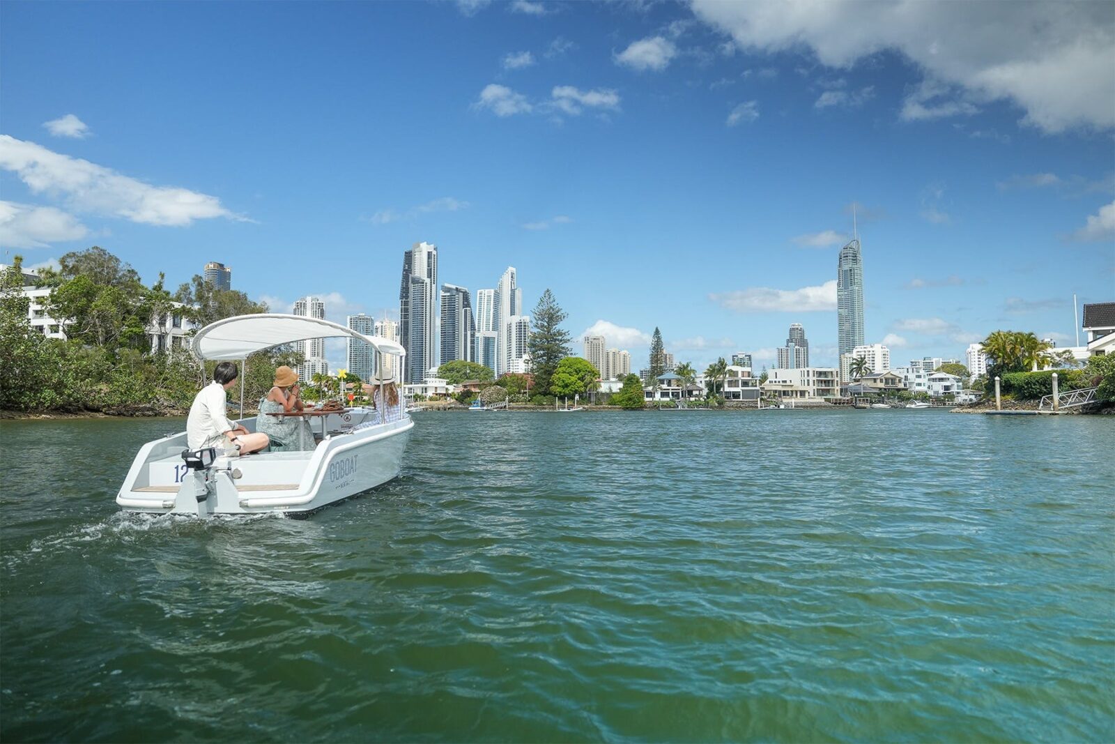 A GoBoat sails on the Nerang River, looking towards Surfers Paradise.