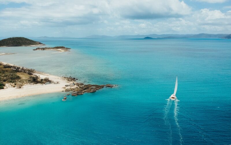 Dufour 56 Vanilla II sailing by Armit Island in the Whitsundays