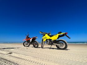 Two dirt bikes on the beach