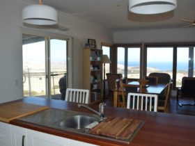 Kitchen, dining room, entrance and view to the sea