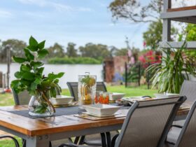 Image of outdoor dining table with chairs overlooking river